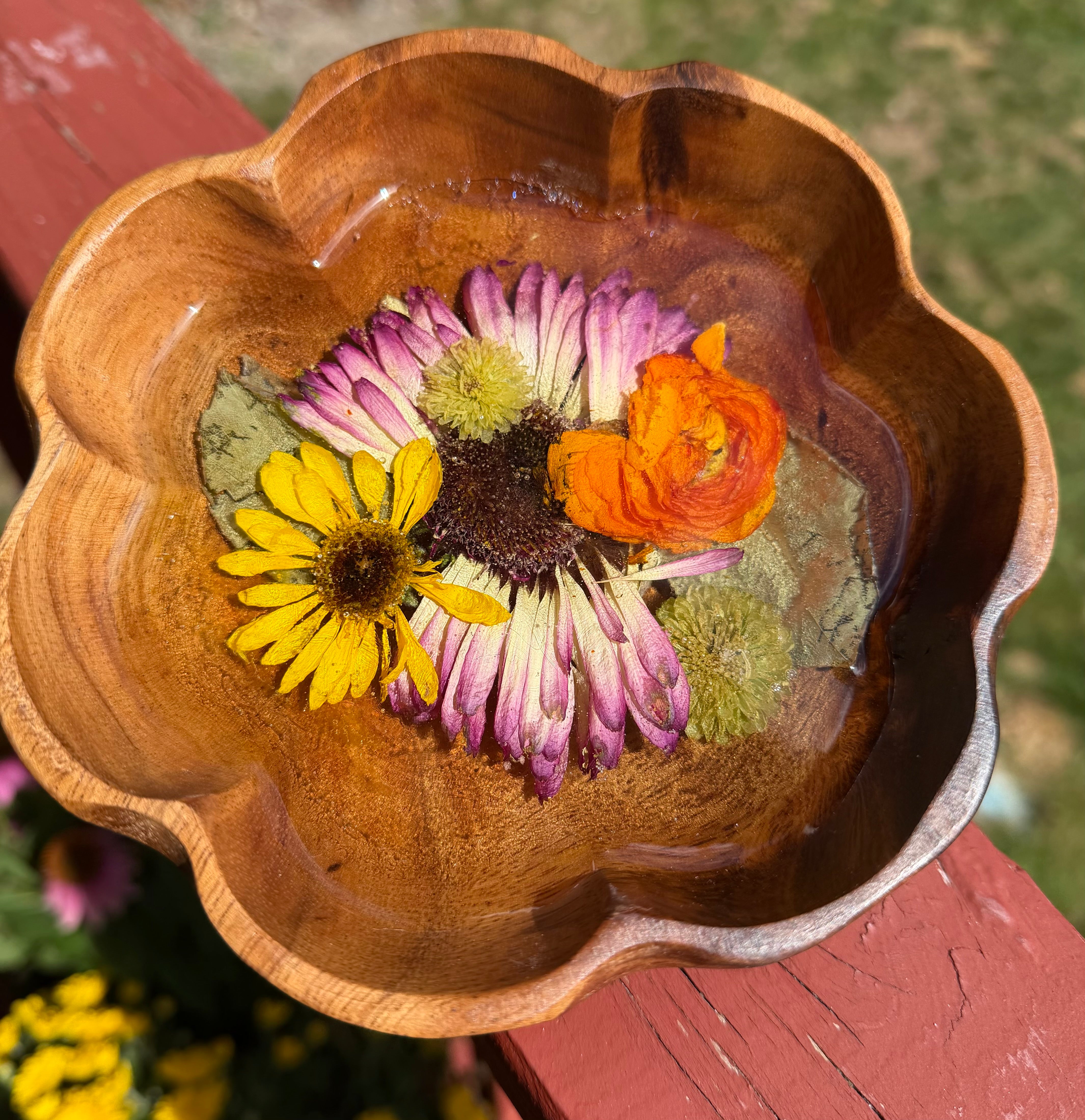 Small scalloped wooden bowl with a purple coneflower, yellow black-eyed Susan, and orange bloom set in clear resin