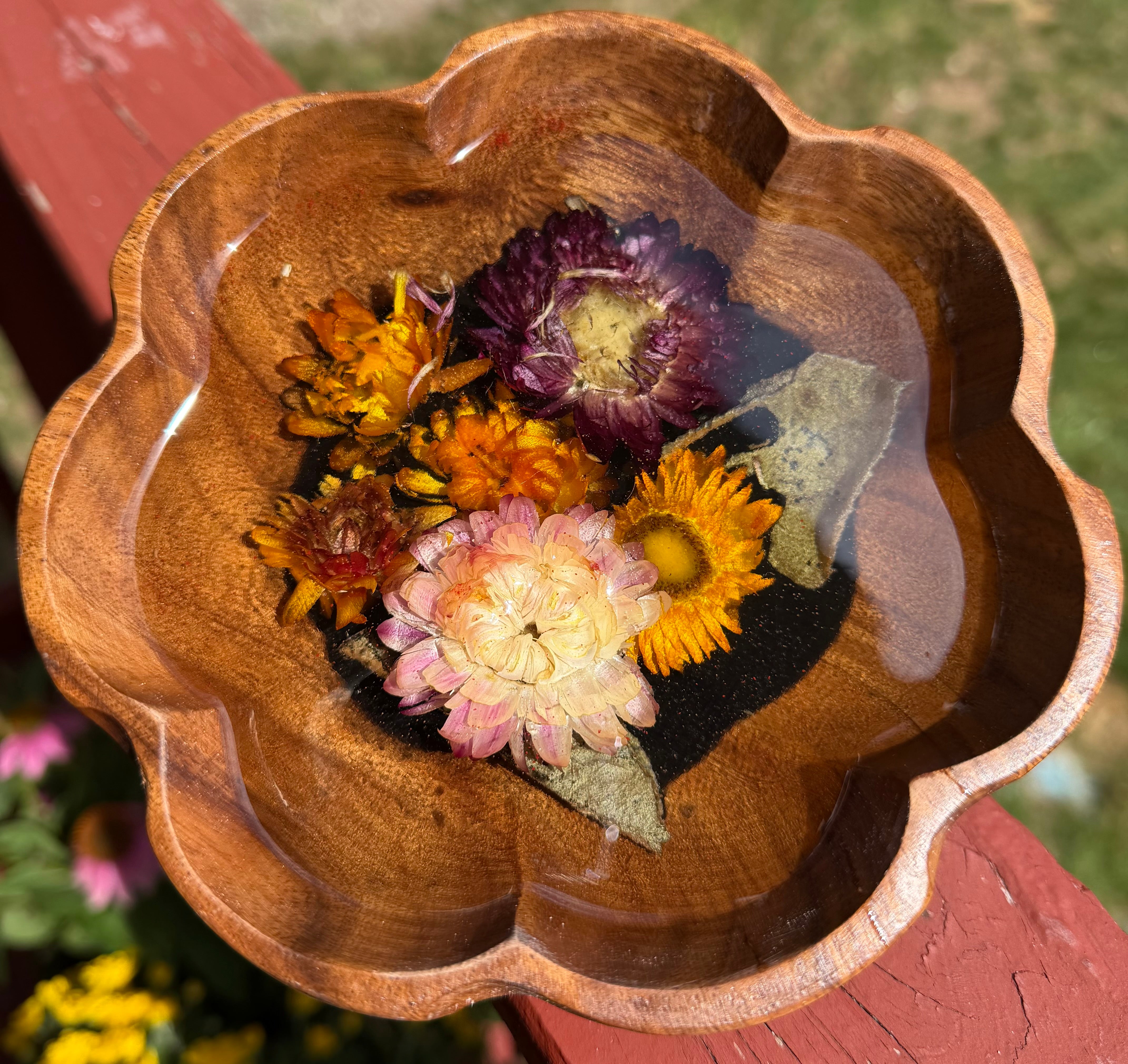 Top view of scalloped wooden bowl with preserved strawflowers in clear resin